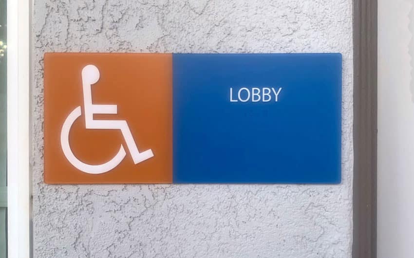 orange, blue, and white lobby identification sign with ISA symbol