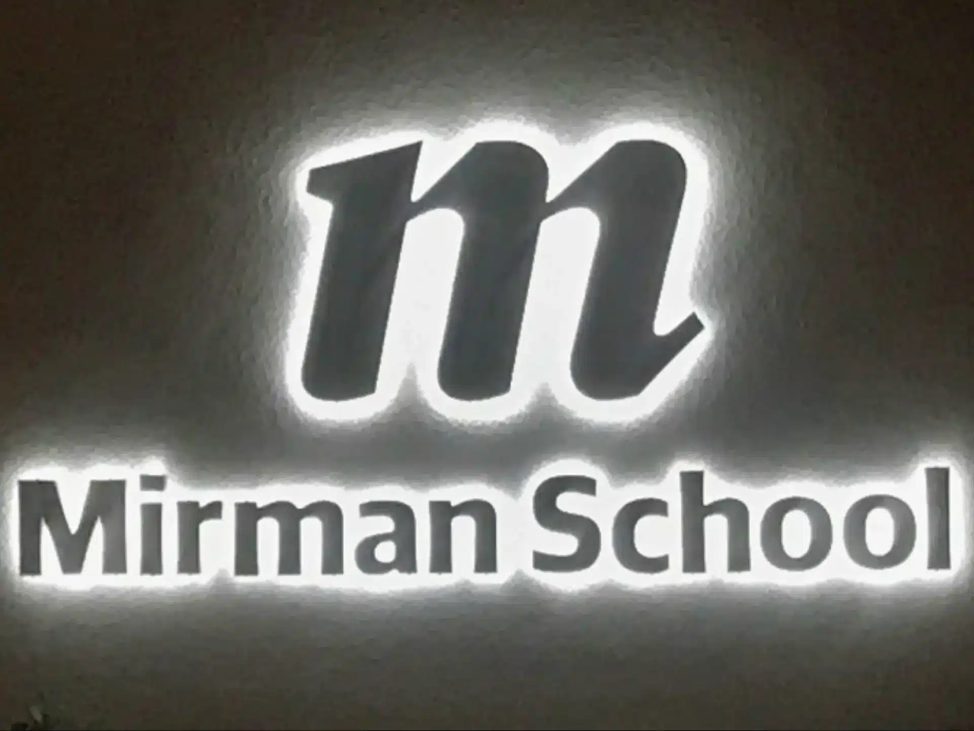 Brushed Aluminum Reverse Lit Channel Letters Mirman School Sign at Night