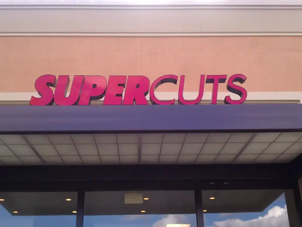 A Supercuts Sign in shopping center