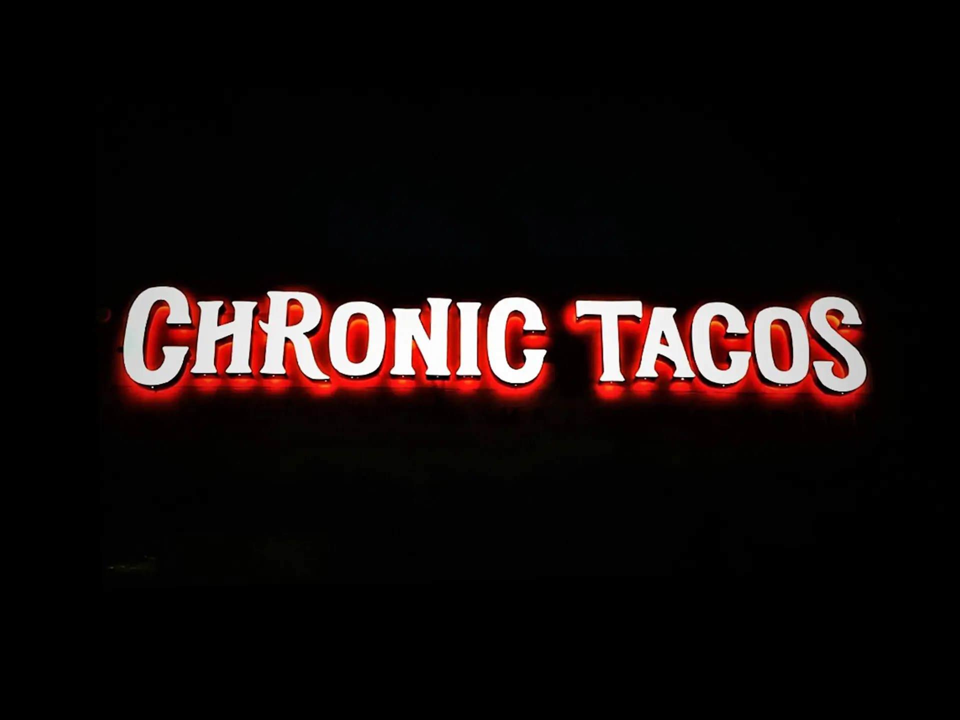 A storefront sign for a taco restaurant