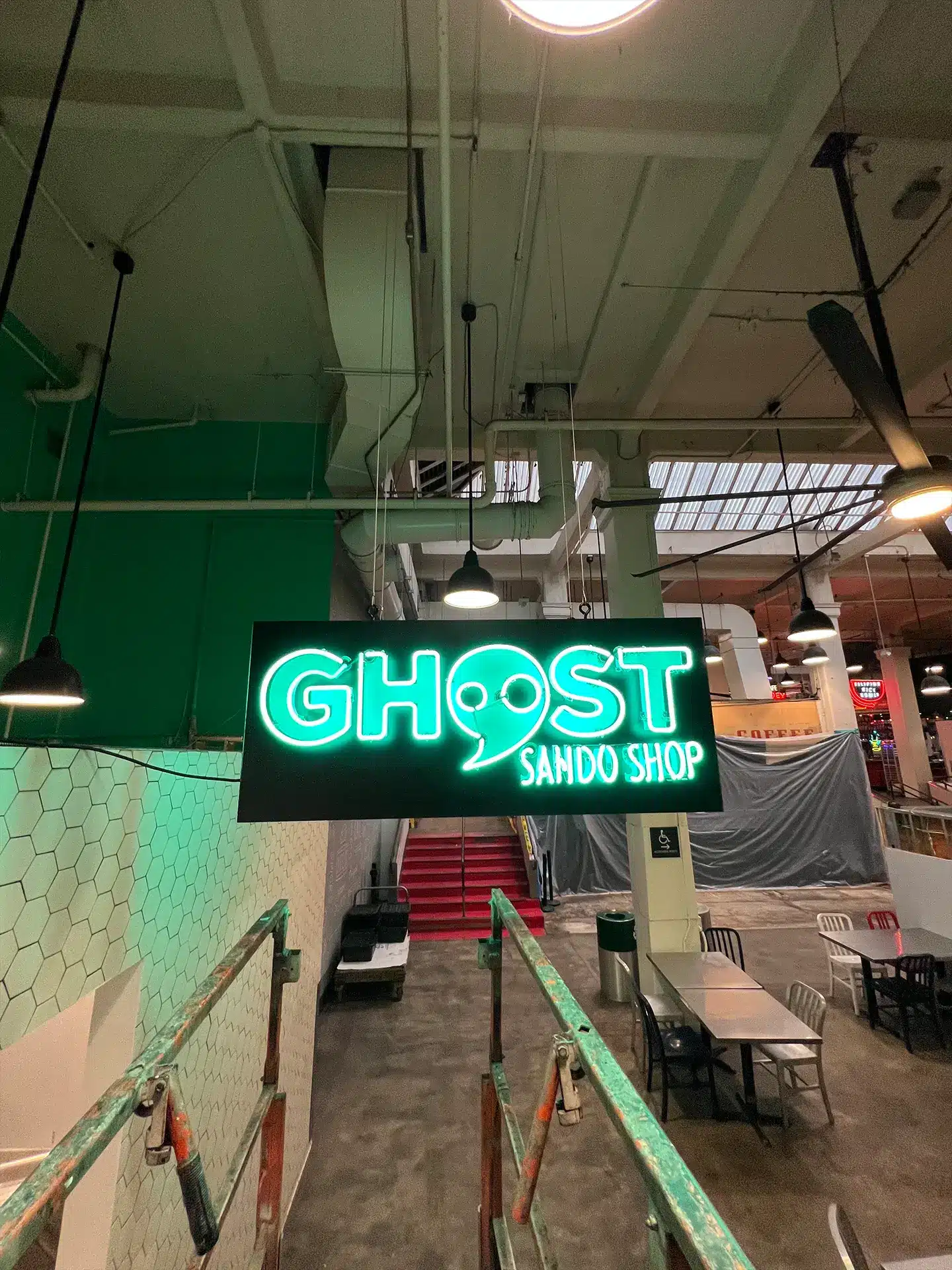neon market sign says ghost sando shop